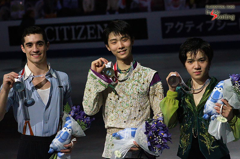 The three medalists in the men's event posing for the photographers